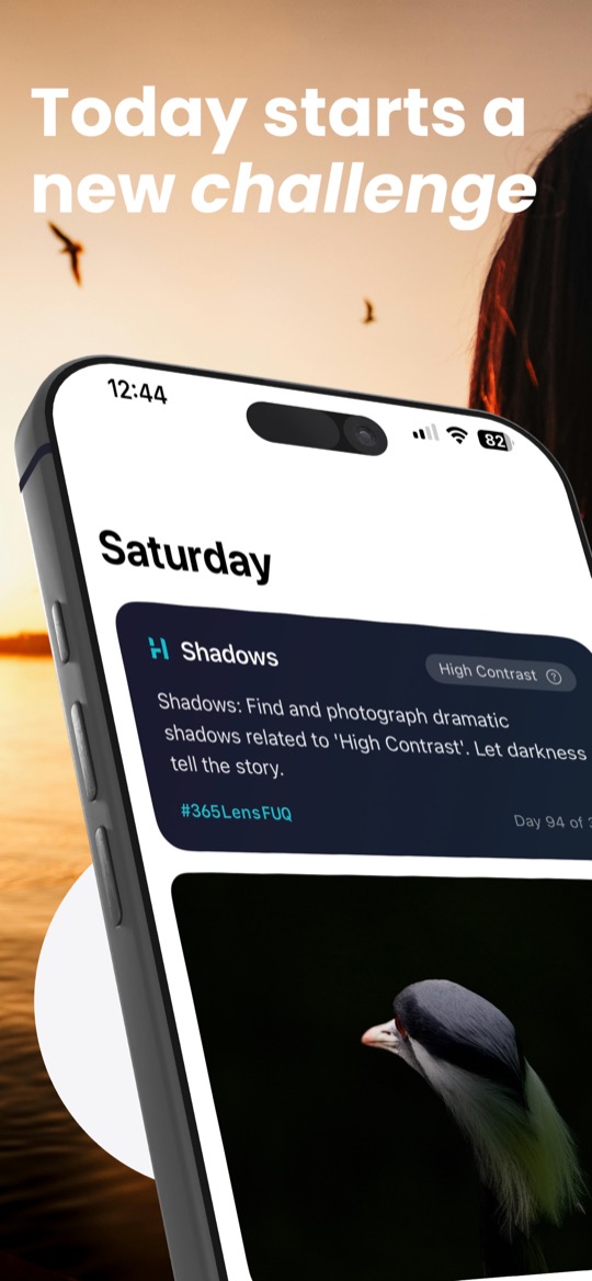 Store image with the headline “Today starts a new challenge” over a sunset by the water, above an angled iPhone: the heading Saturday, a dark card for the category Shadows with the theme High Contrast, the prompt text and the hashtag #365LensFUQ, and below it, cut off, a photo of a bird against a black background